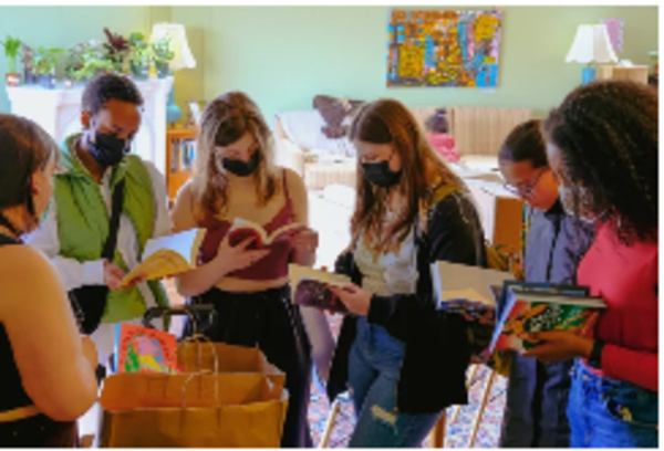 Students browsing and reading books together at the library