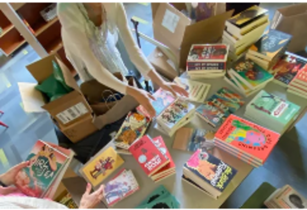 Volunteers unpacking donated books for the anti-racism library